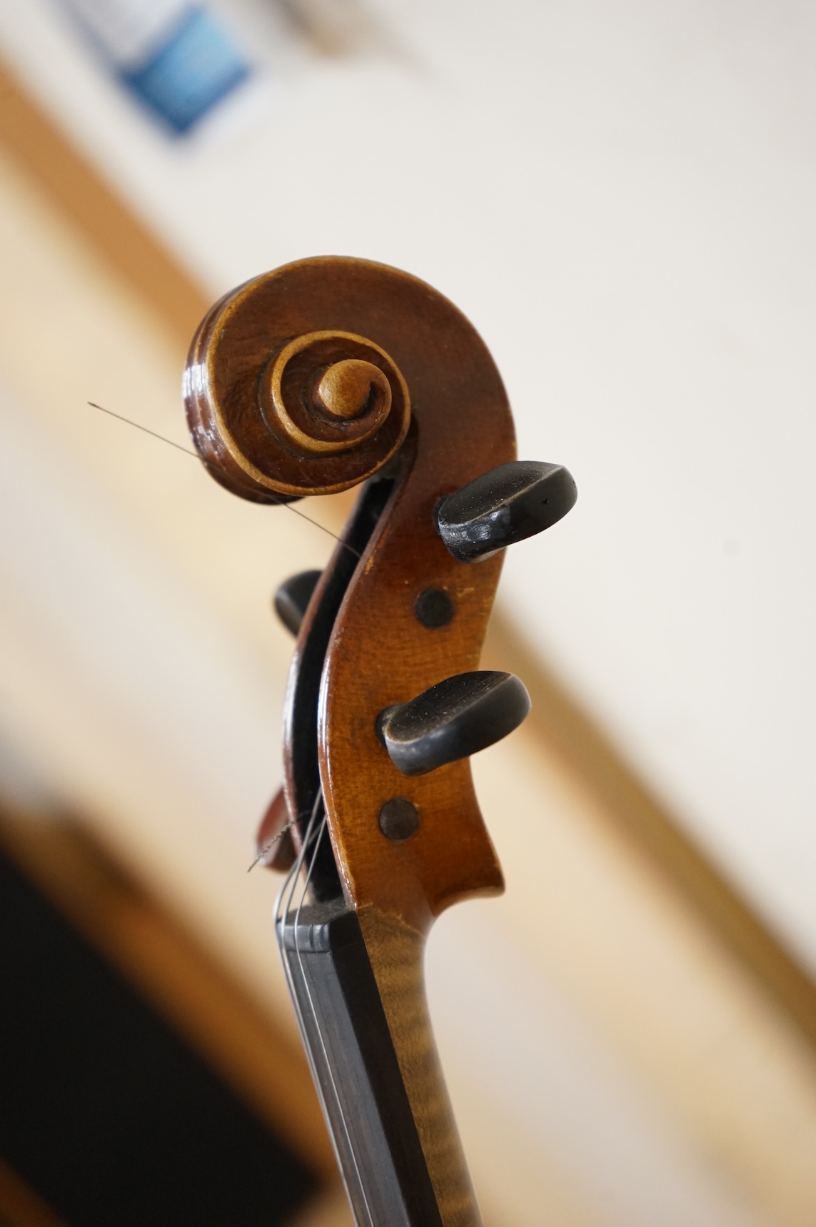 Five cased 20th century violins, including; a German violin, two Czech violins, a three-quarter size violin with a label for Bienfait, and a Romanian quarter size violin, all in cases or the remains of cases.
